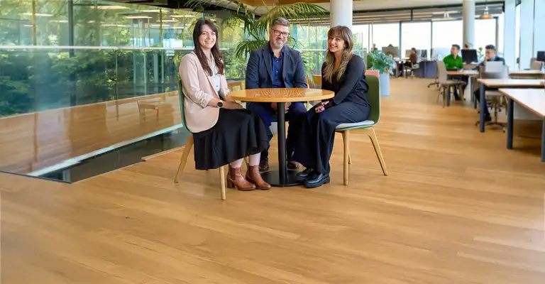 Three Kiwibank economists sitting at a table