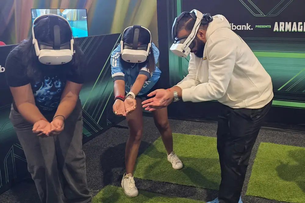 Three people wearing virtual reality headsets playing an interactive game.