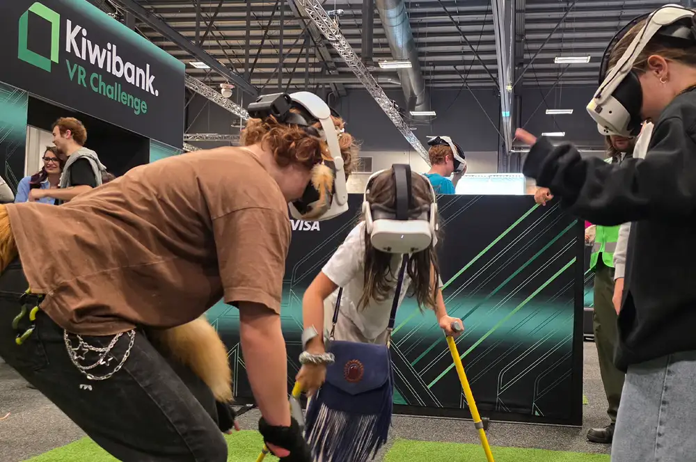 Three people wearing virtual reality headsets playing an interactive game.