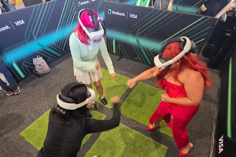 Four people wearing virtual reality headsets playing an interactive game.