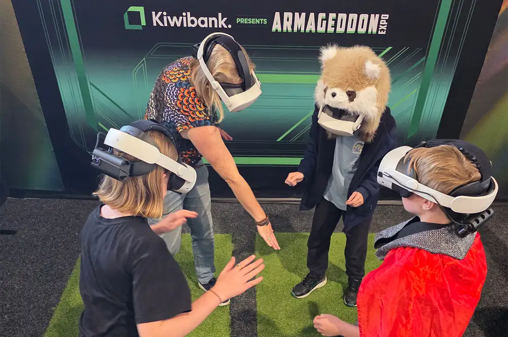 Four people wearing virtual reality headsets playing an interactive game.