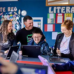 Banqer and Kiwibank staff with a student in a classroom