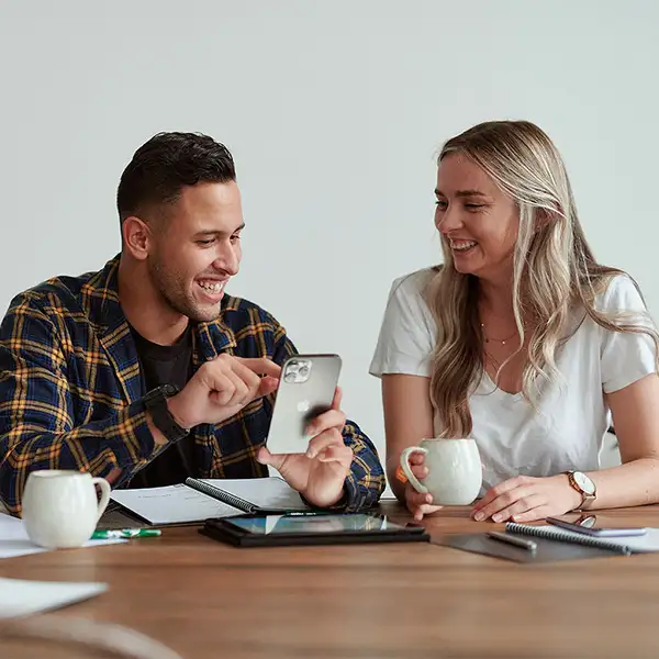 Couple smiling on phone