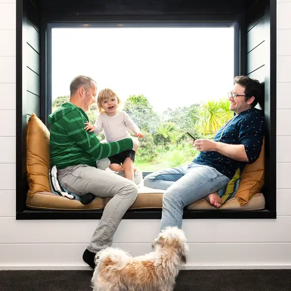 Couple with kid on window seat