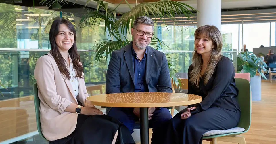 Three Kiwibank economists sitting at a table