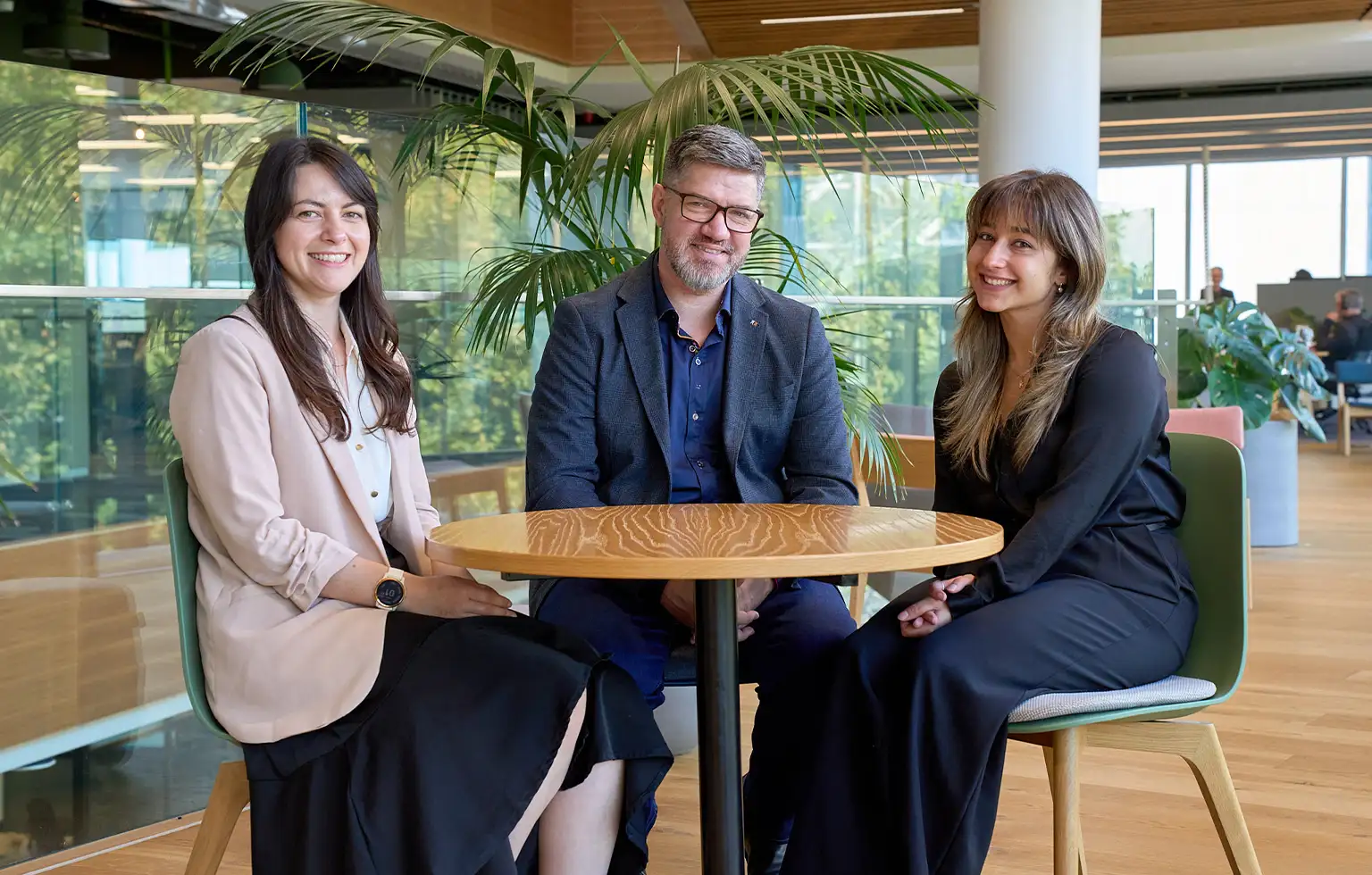 Three Kiwibank economists sitting at a table