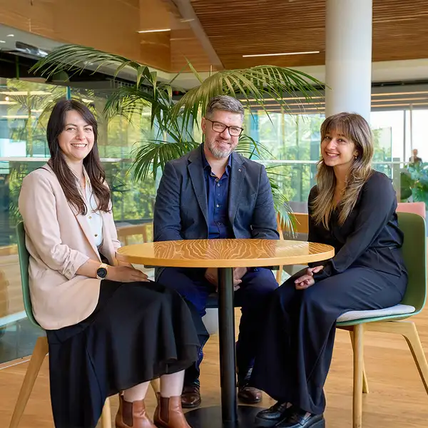 Three Kiwibank economists sitting at a table
