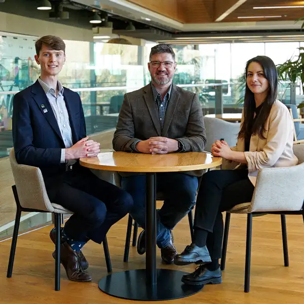 Three Kiwibank economists sitting at a table