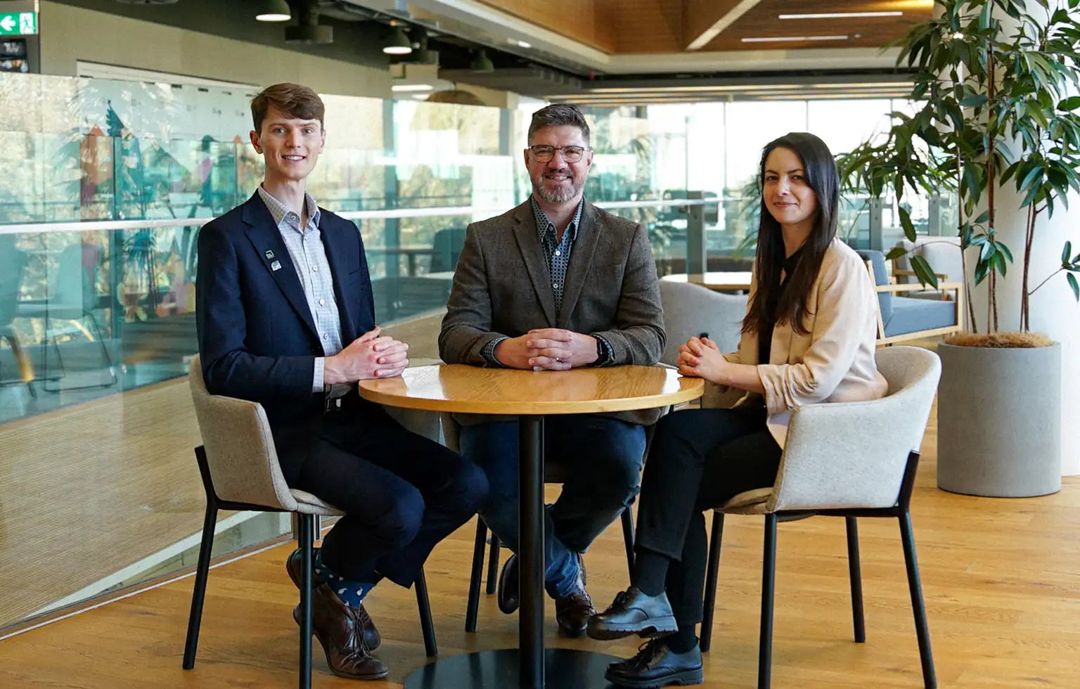 Three Kiwibank economists sitting at a table