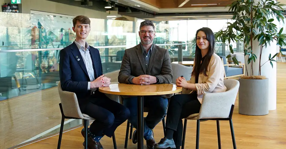 Three Kiwibank economists sitting at a table