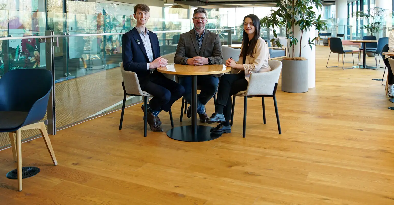 Three Kiwibank economists sitting at a table