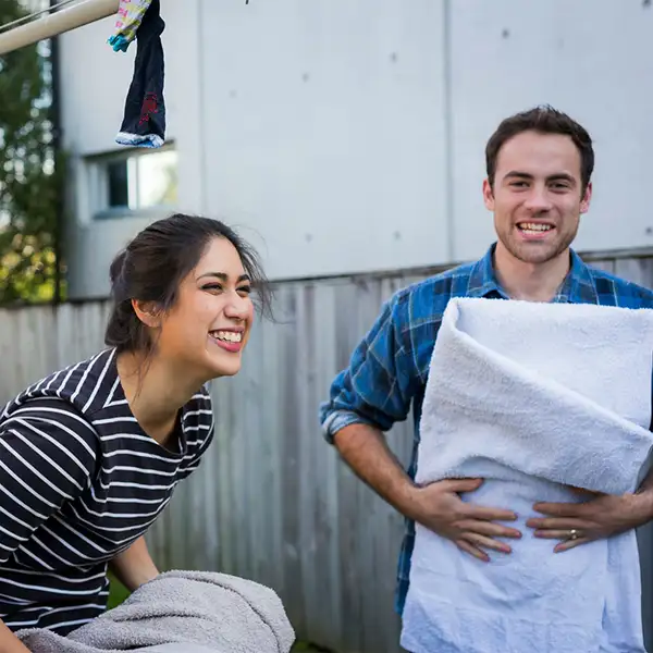 Friends folding washing