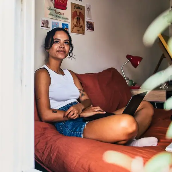 Girl on bed looking out window