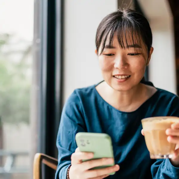Woman on phone with coffee
