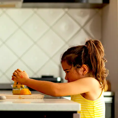 Kids squeezing lemons