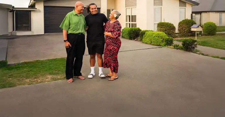 Parents-with-adult-son-family_in_driveway