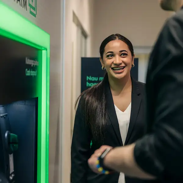 Staff at ATM with Customer Tight Shot