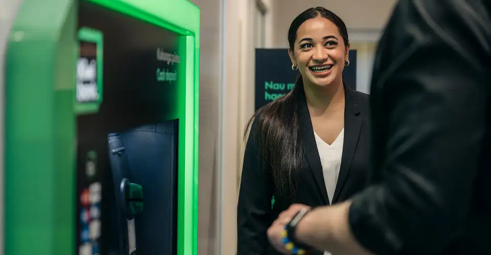 Staff at ATM with Customer Tight Shot