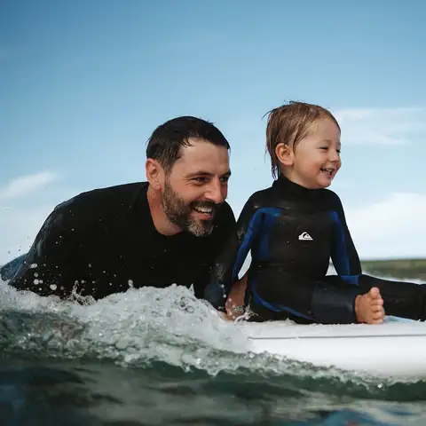 dad & boy surfing 960x960