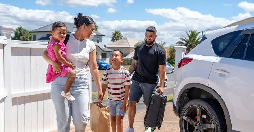 Family by car on driveway