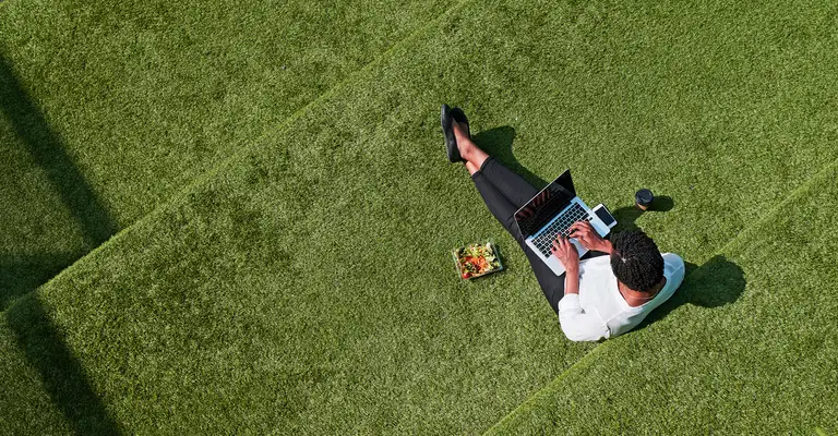 Lady on laptop in backyard