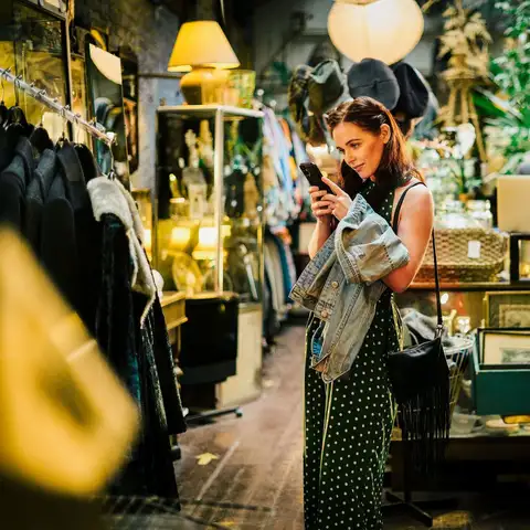 woman in shop on her phone