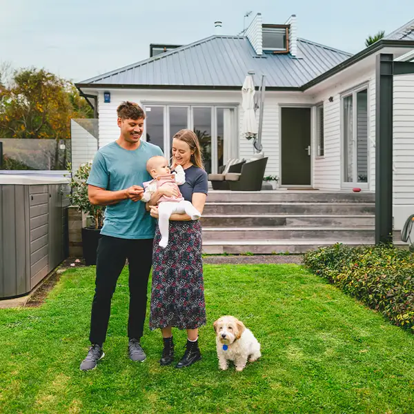 Young family with dog in the backyard
